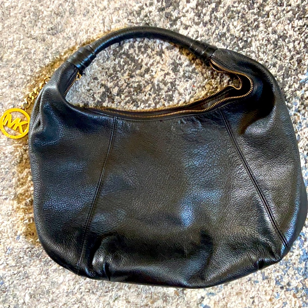 Genuine Michael Kors black hobo bag with gold MK medallion.